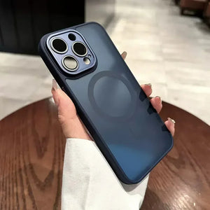 Person holding a phone with a black case on a wooden surface